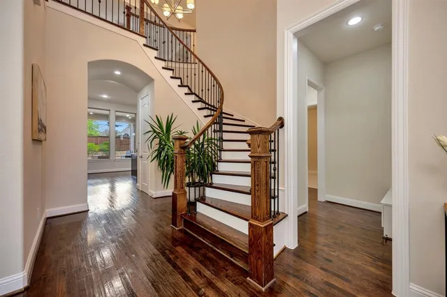a view of entryway and hall with wooden floor