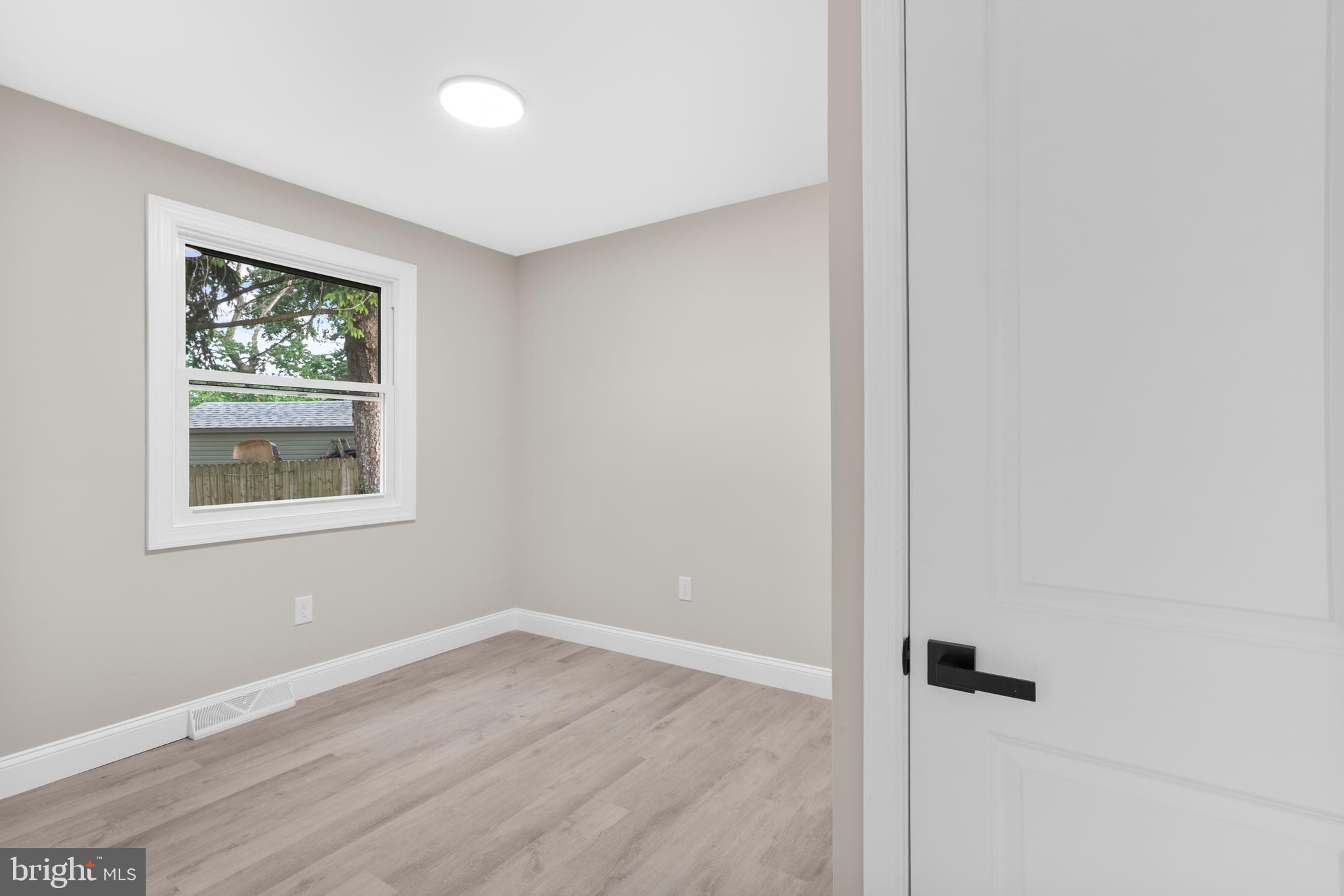 1 Gainor Avenue Maple Shade, NJ 08052 - Photo 13 of 27 an empty room with wooden floor and a window