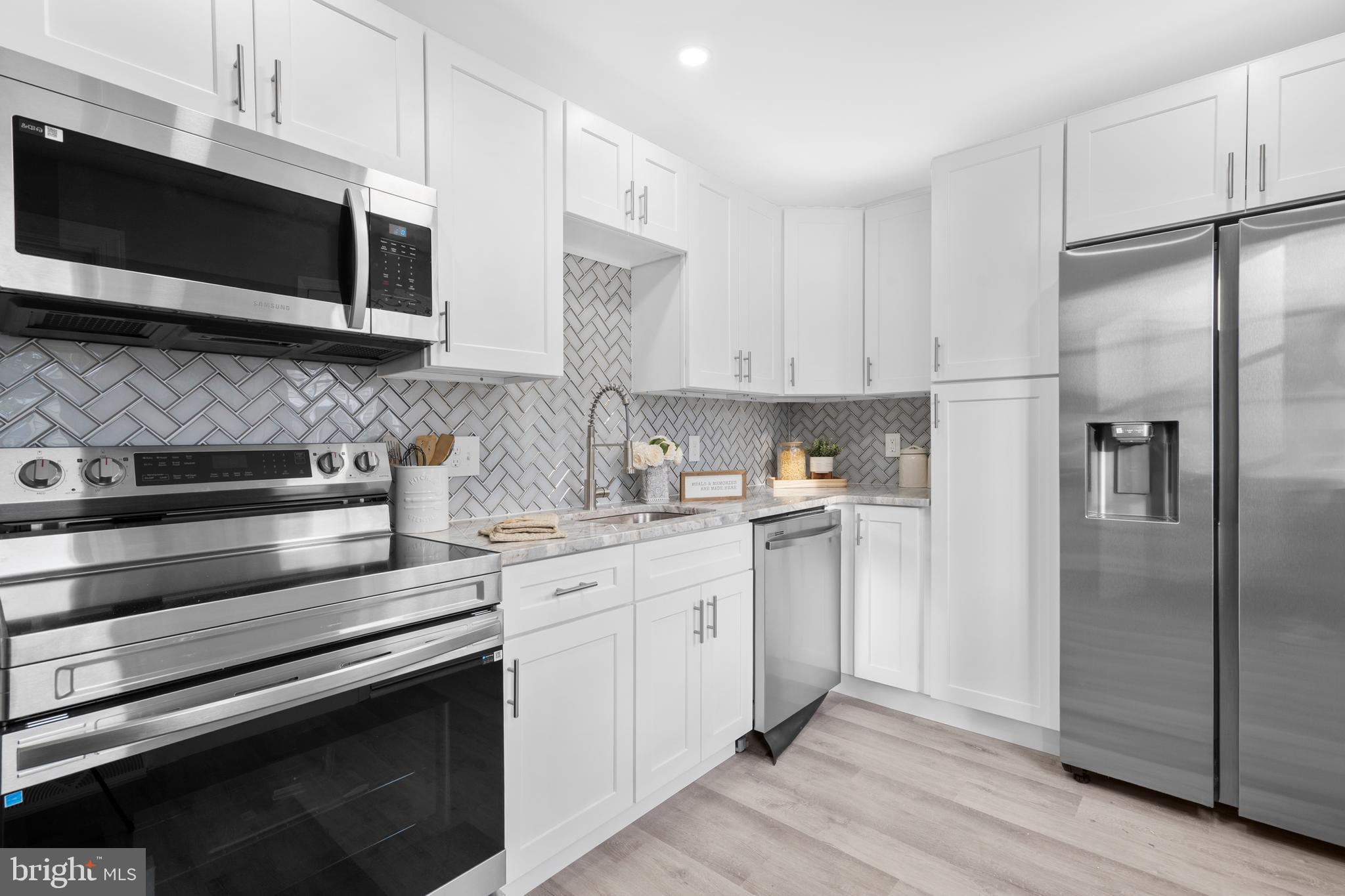 1 Gainor Avenue Maple Shade, NJ 08052 - Photo 4 of 27 a kitchen with stainless steel appliances white cabinets a sink and a microwave