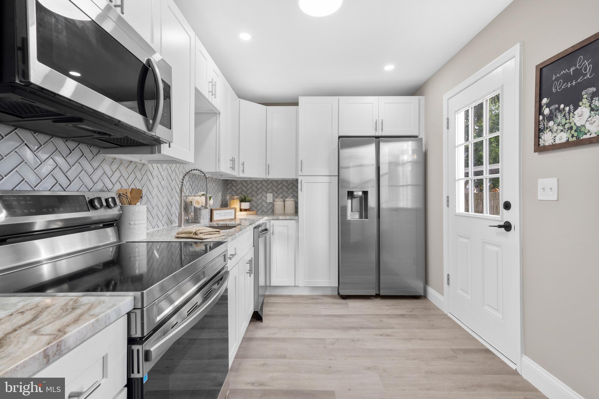 1 Gainor Avenue Maple Shade, NJ 08052 - Photo 6 of 27 a kitchen with stainless steel appliances granite countertop a refrigerator a stove and a microwave