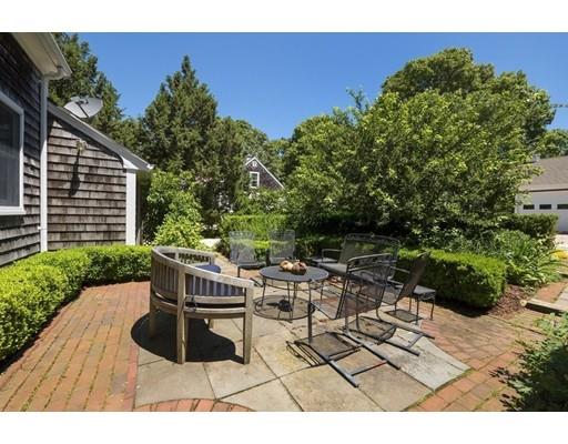 45 Gibson Road Orleans, MA 02653 - Photo 12 of 29 a backyard of a house with table and chairs