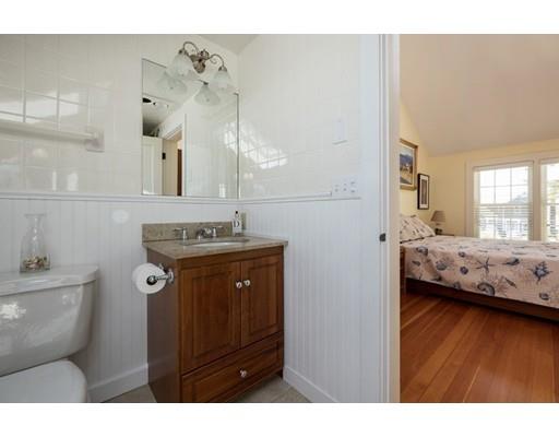 45 Gibson Road Orleans, MA 02653 - Photo 18 of 29 a en suite bathroom with a granite countertop sink and a mirror