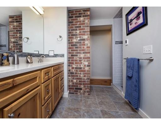45 Gibson Road Orleans, MA 02653 - Photo 21 of 29 a bathroom with a sink a mirror and shower