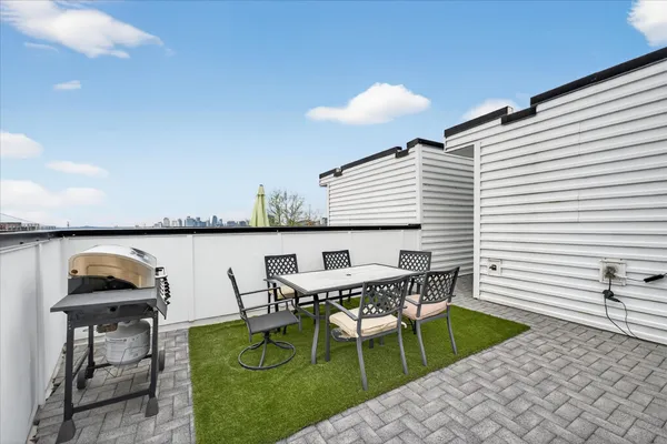 a view of a patio with table and chairs and potted plants