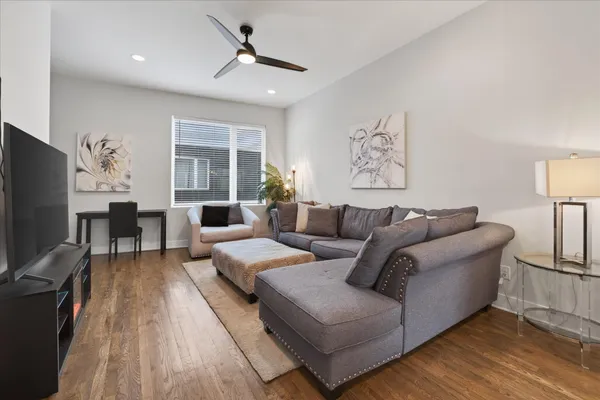 a living room with furniture a large window and a flat screen tv