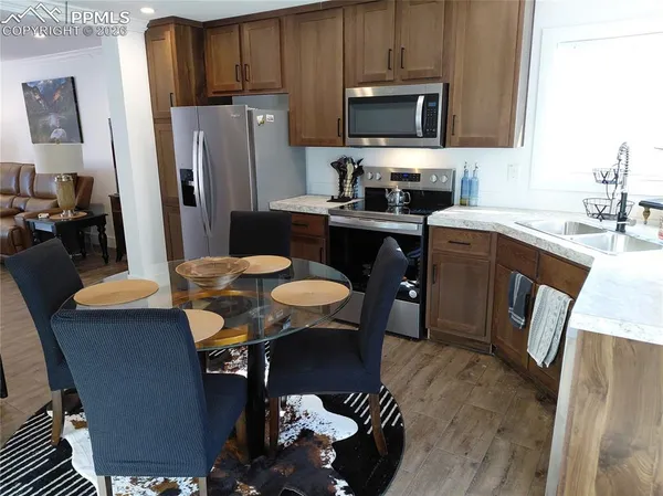 a kitchen with stainless steel appliances a refrigerator stove microwave and sink