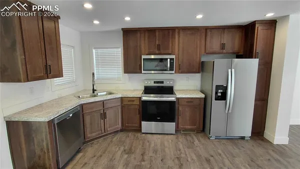 a kitchen with a table chairs sink and cabinets