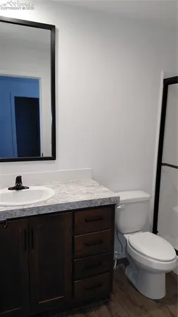 a white toilet sitting next to a shower