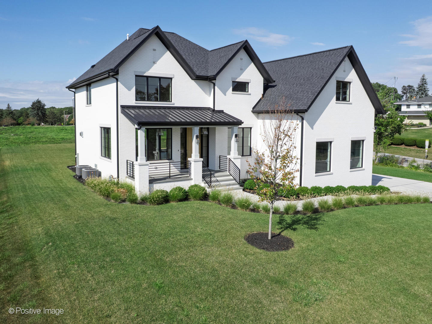 a view of a house with a yard and potted plants