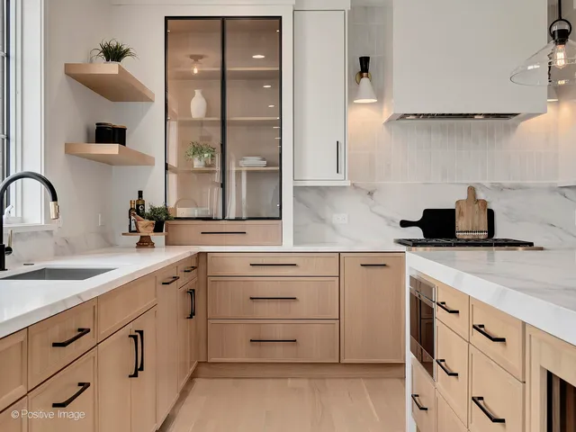 a kitchen with cabinets appliances a sink and a window