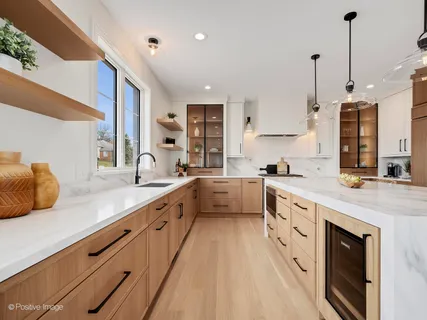 a large kitchen with stainless steel appliances kitchen island granite countertop a sink and cabinets