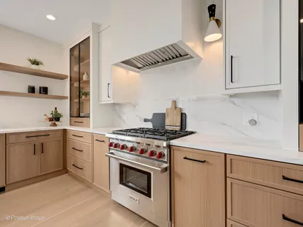 a kitchen with white cabinets and appliances