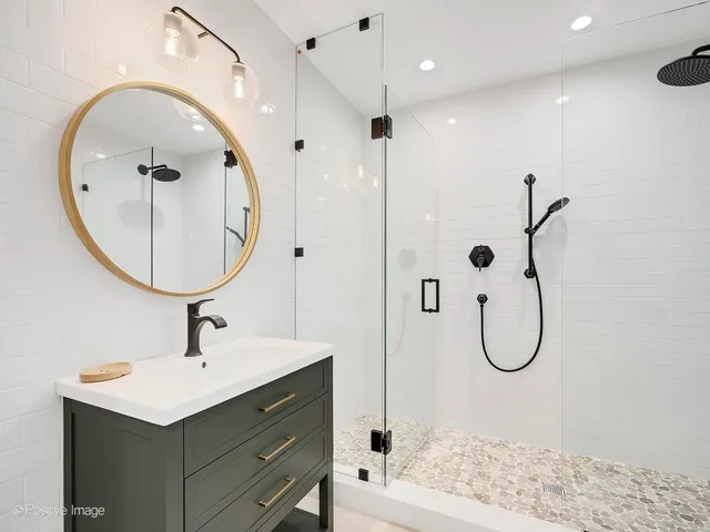 a bathroom with a sink a mirror and a shower