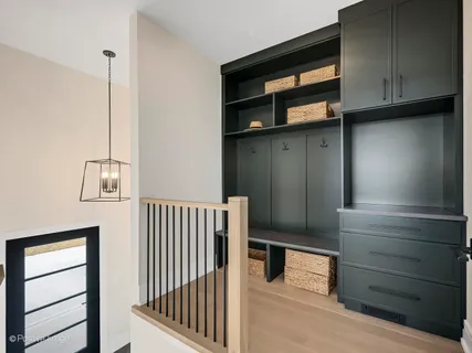 a view of entryway and hall with wooden cabinet