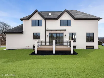 a front view of a house with a garden and yard