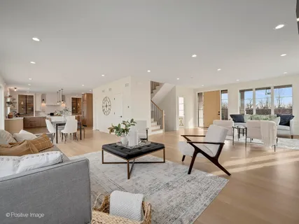 a living room with furniture and view of kitchen