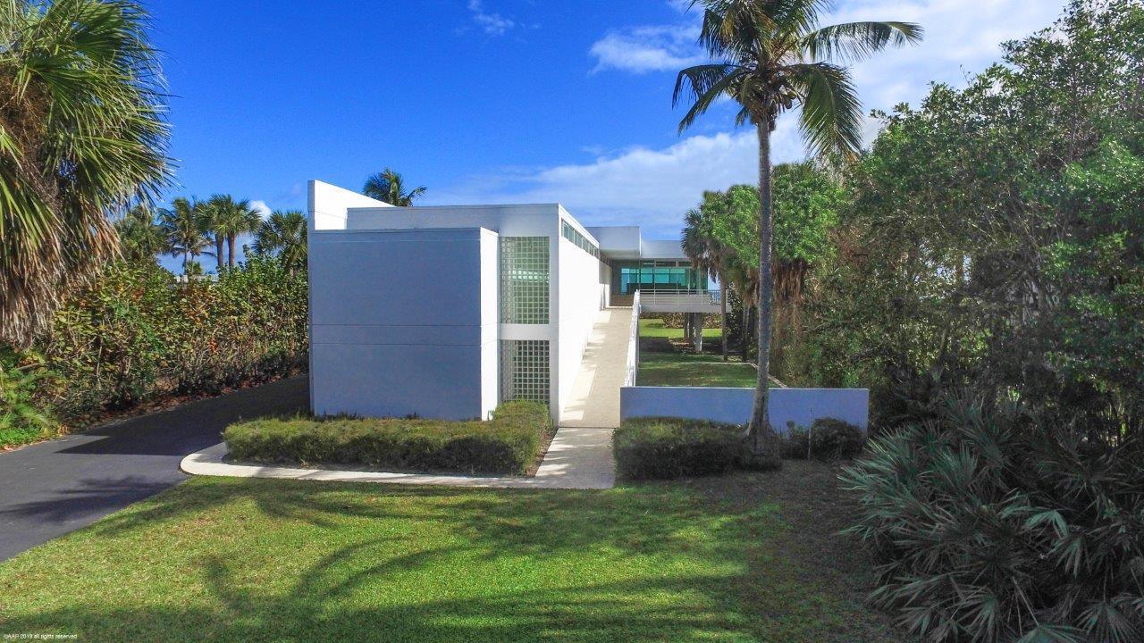 35 North Beach Road Hobe Sound, FL 33455 - Photo 11 of 44 a front view of a house with a yard