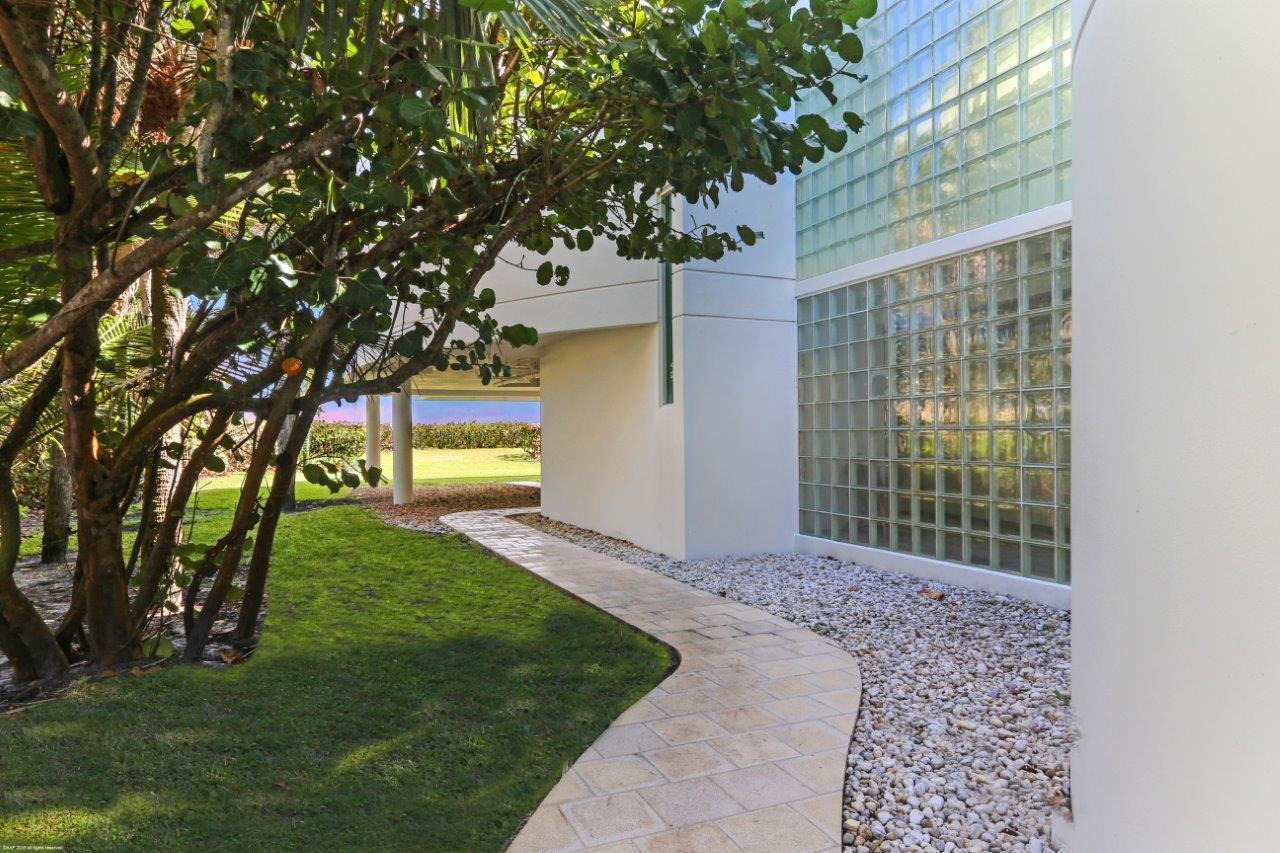 35 North Beach Road Hobe Sound, FL 33455 - Photo 13 of 44 a front view of a house with a garden