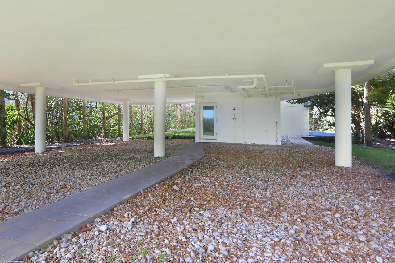 35 North Beach Road Hobe Sound, FL 33455 - Photo 17 of 44 a view of a house with a yard