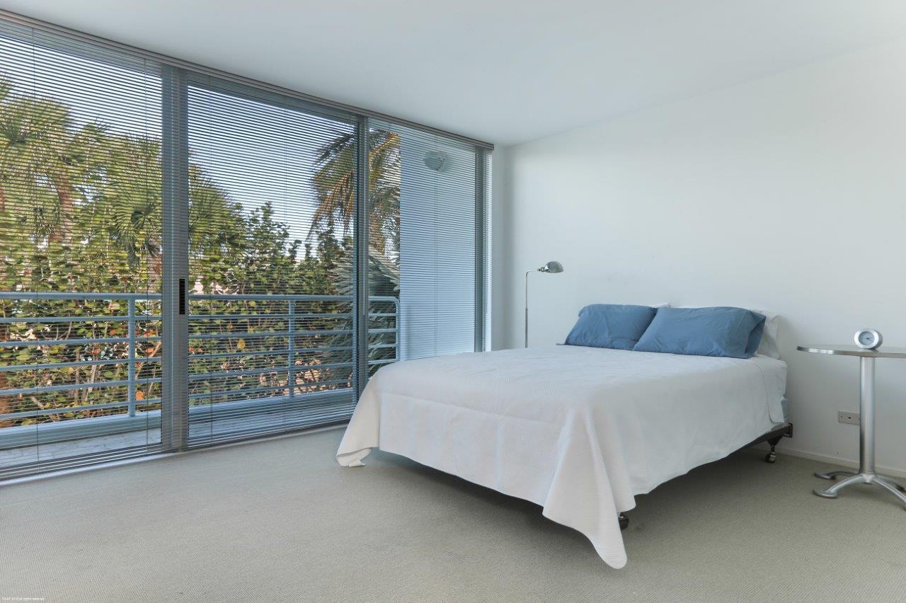 35 North Beach Road Hobe Sound, FL 33455 - Photo 31 of 44 a bed sitting in a room next to a window