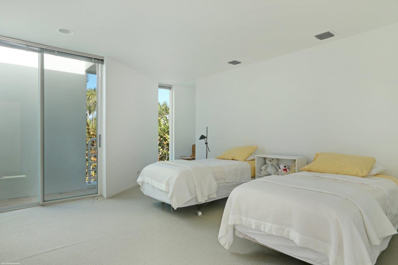 35 North Beach Road Hobe Sound, FL 33455 - Photo 34 of 44 a bedroom with two beds and painted walls