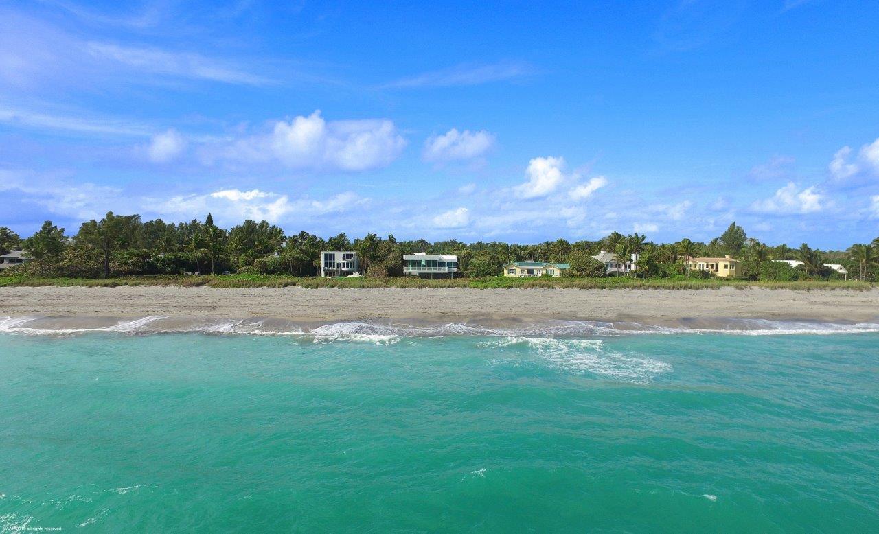 35 North Beach Road Hobe Sound, FL 33455 - Photo 39 of 44 a view of a lake with houses in the background