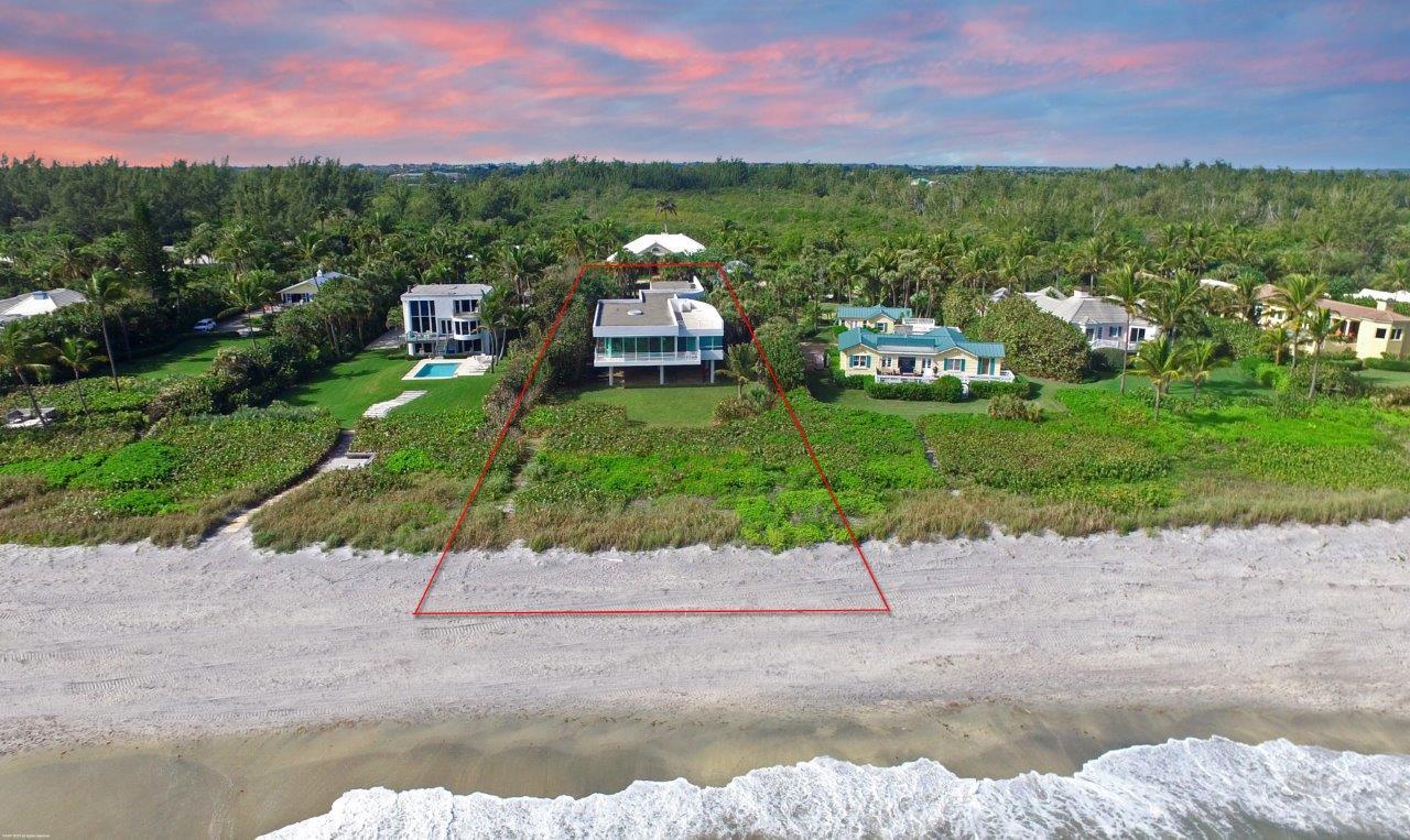 35 North Beach Road Hobe Sound, FL 33455 - Photo 10 of 44 a front view of a house with a yard and a garage
