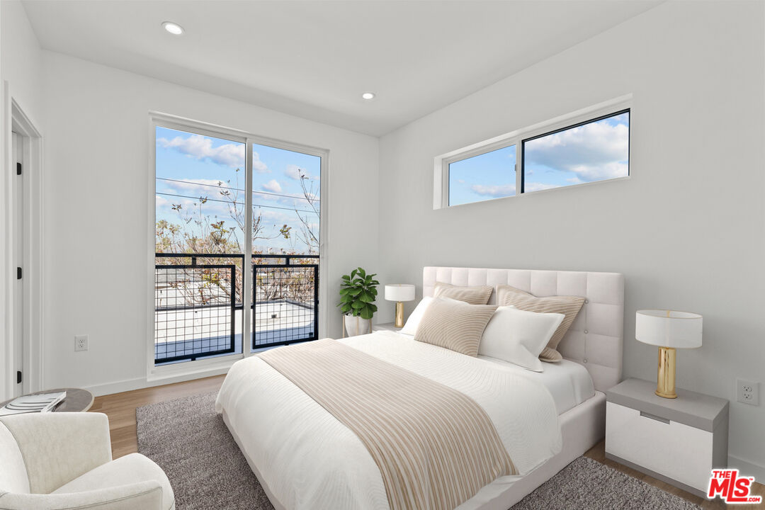 2923 South Burnside Avenue Los Angeles, CA 90016 - Photo 12 of 26 a bedroom with a large bed and a window