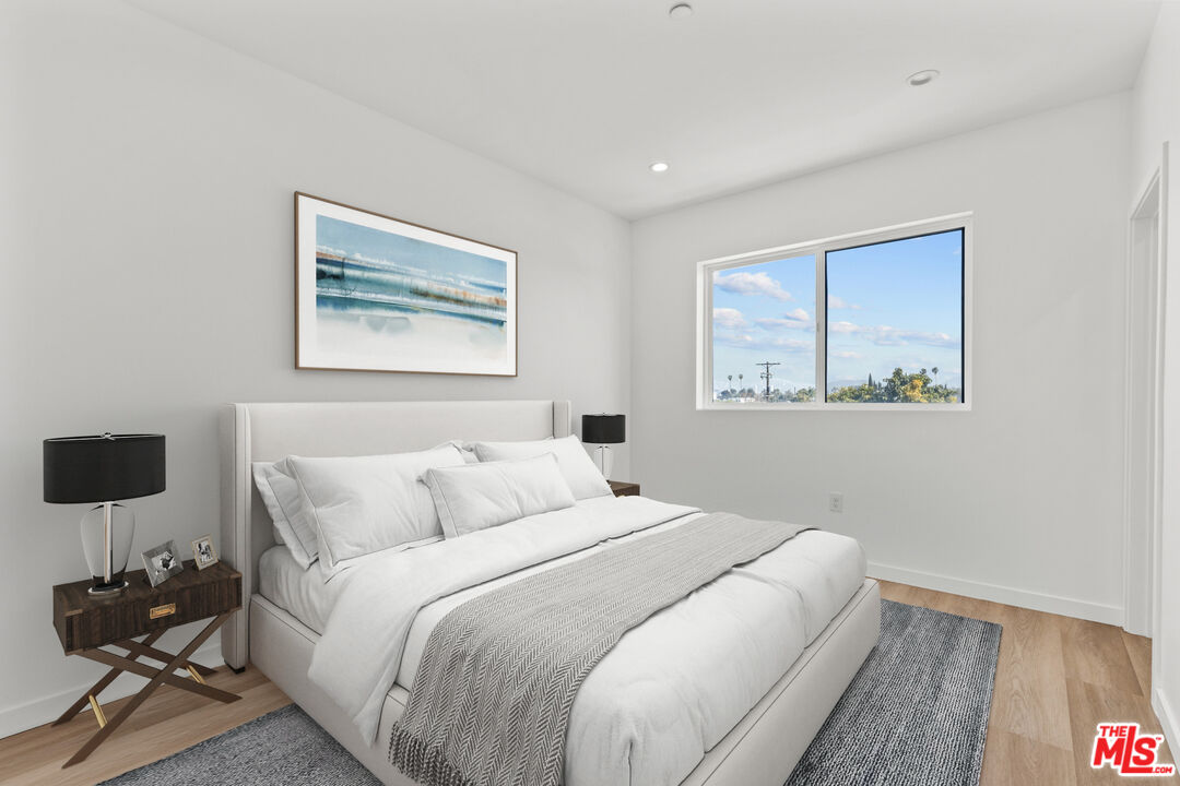 2923 South Burnside Avenue Los Angeles, CA 90016 - Photo 14 of 26 a bedroom with double bed and a night stand