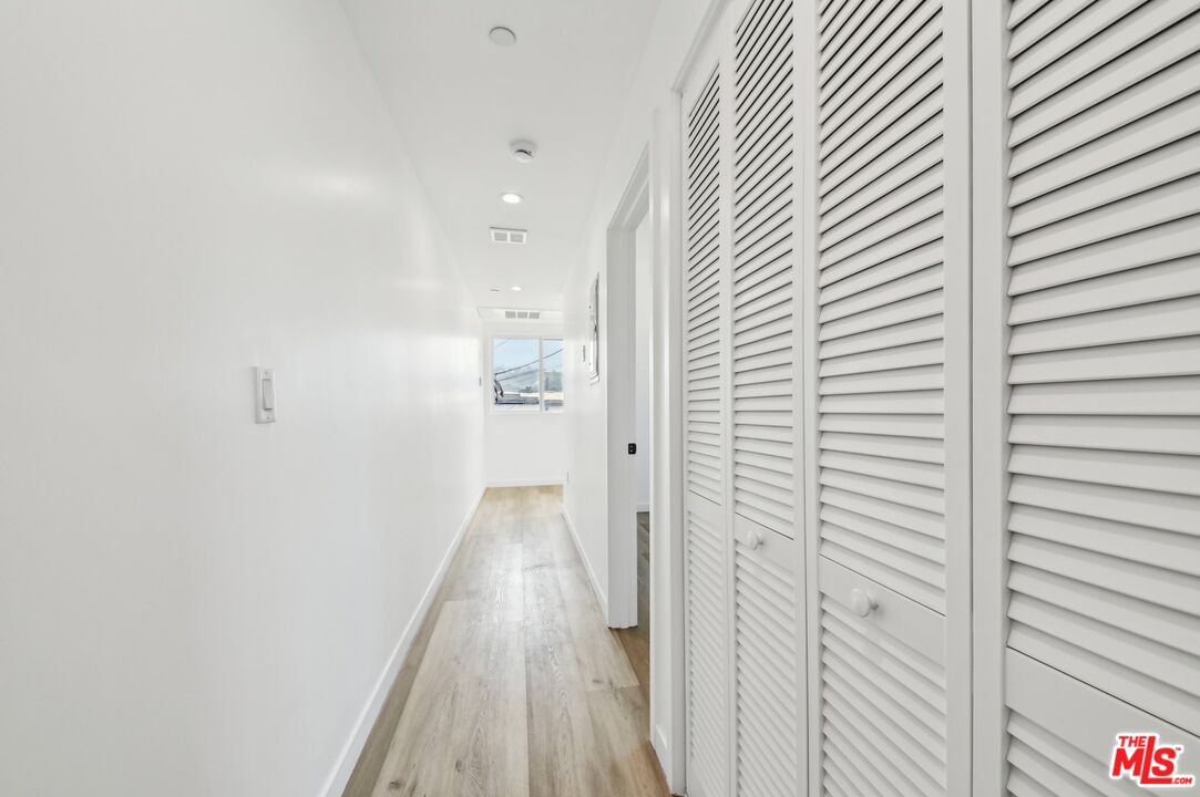 2923 South Burnside Avenue Los Angeles, CA 90016 - Photo 18 of 26 a view of a hallway with wooden floor
