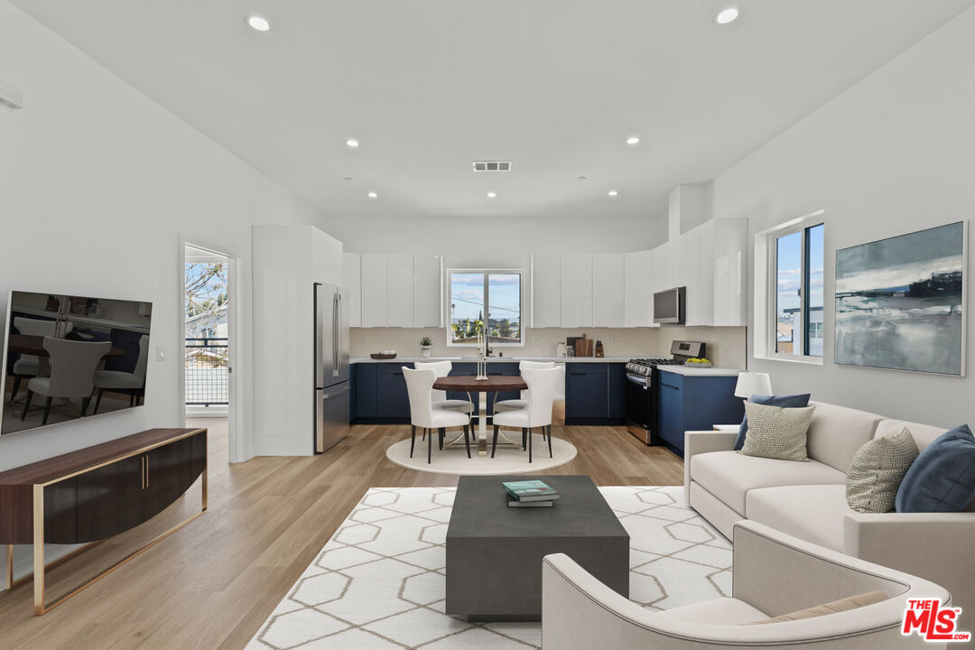 2923 South Burnside Avenue Los Angeles, CA 90016 - Photo 3 of 26 a living room with furniture and a flat screen tv