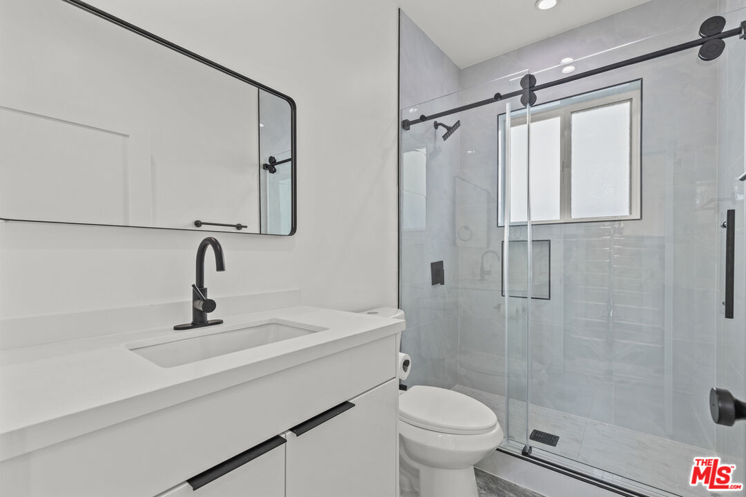 2923 South Burnside Avenue Los Angeles, CA 90016 - Photo 10 of 26 a bathroom with a sink a toilet and shower