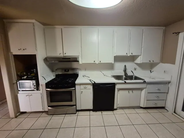 a bathroom with a glass door shower a sink and a mirror