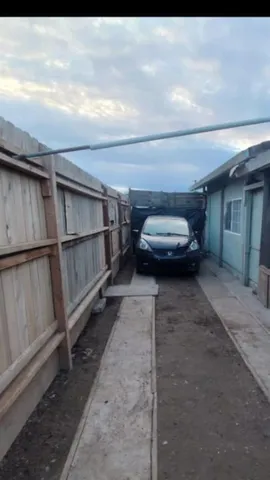 a view of backyard with wooden fence