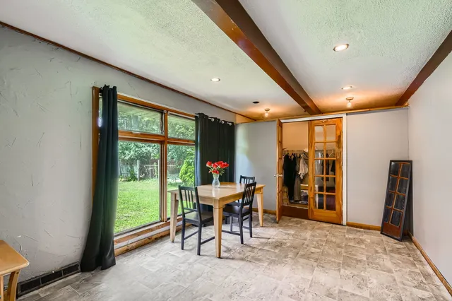 a view of a room with furniture and a large window