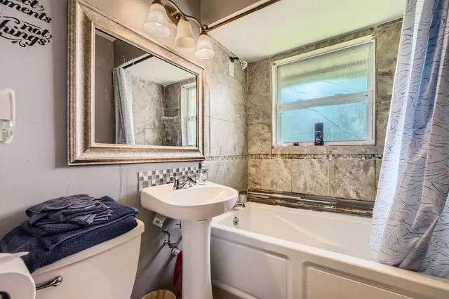 a bathroom with a sink a mirror and a bathtub
