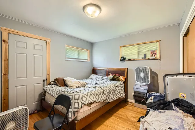 a bedroom with bed and a window