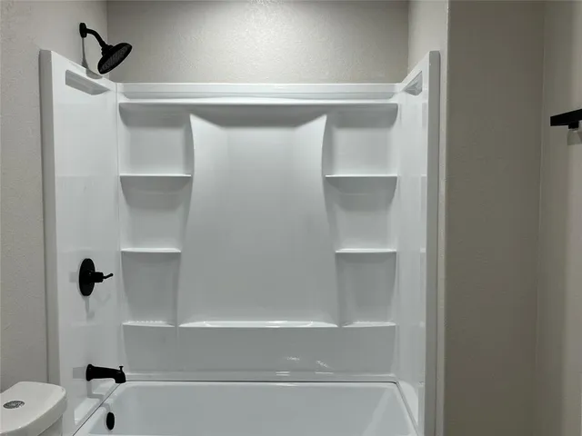 an empty room with wooden floor and closet