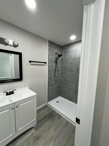 a bathroom with a bathtub a sink and a mirror