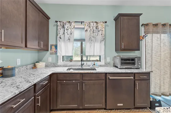 a kitchen with stainless steel appliances granite countertop a sink and a cabinets