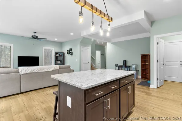 a kitchen with kitchen island a counter top space appliances and cabinets