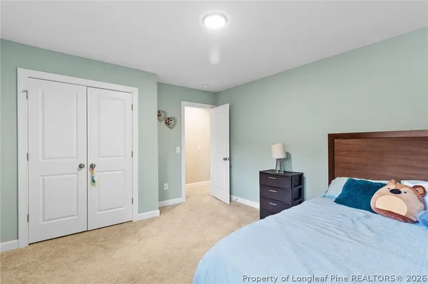 a bedroom with a bed and a closet