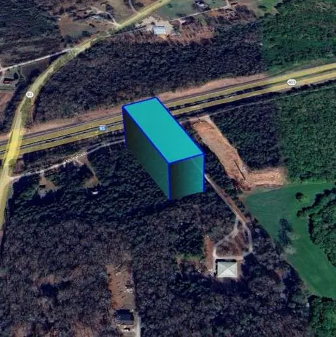 a green field with lots of trees