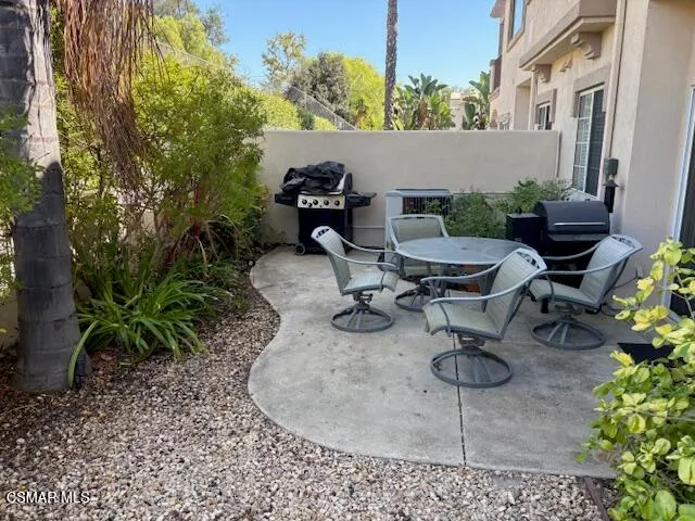 a view of a backyard with plants and sitting area