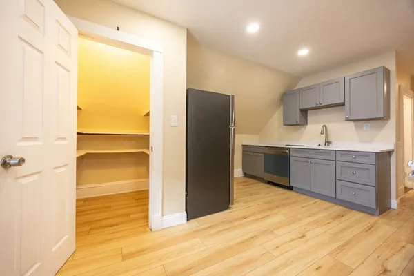 a kitchen with a refrigerator and a sink