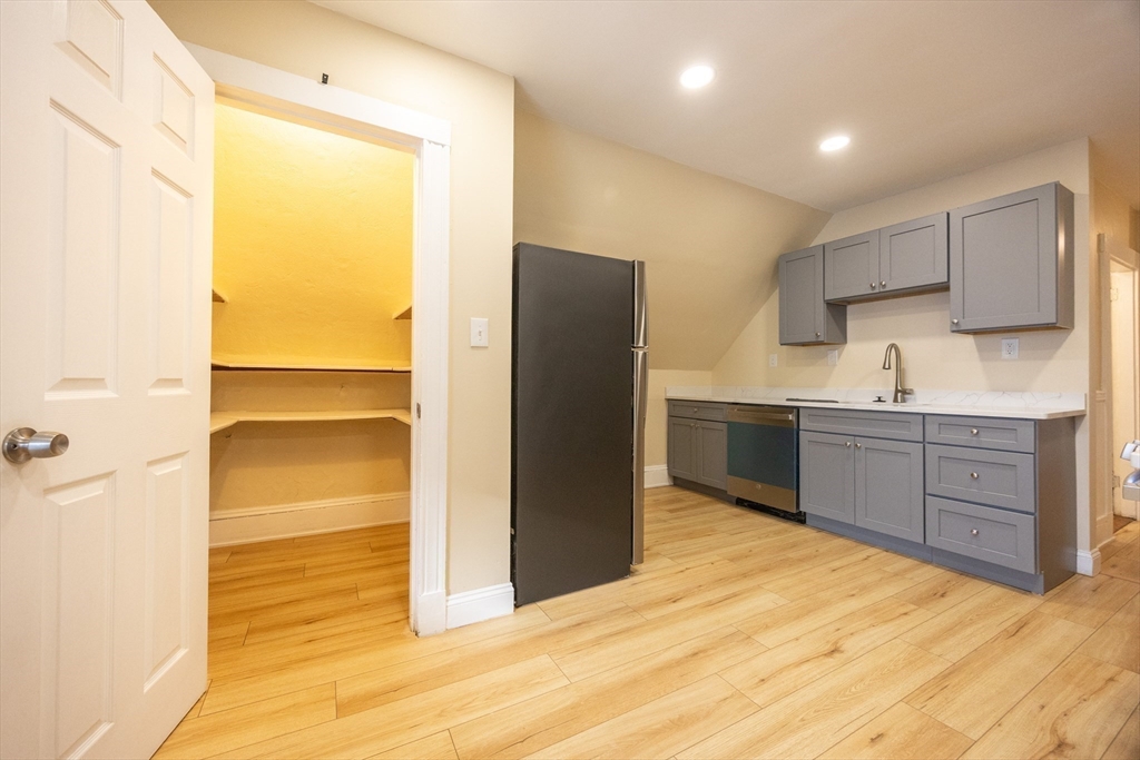 529 Adams Street, Unit 3 Boston, MA 02122 - Photo 4 of 11 a kitchen with a refrigerator and a sink