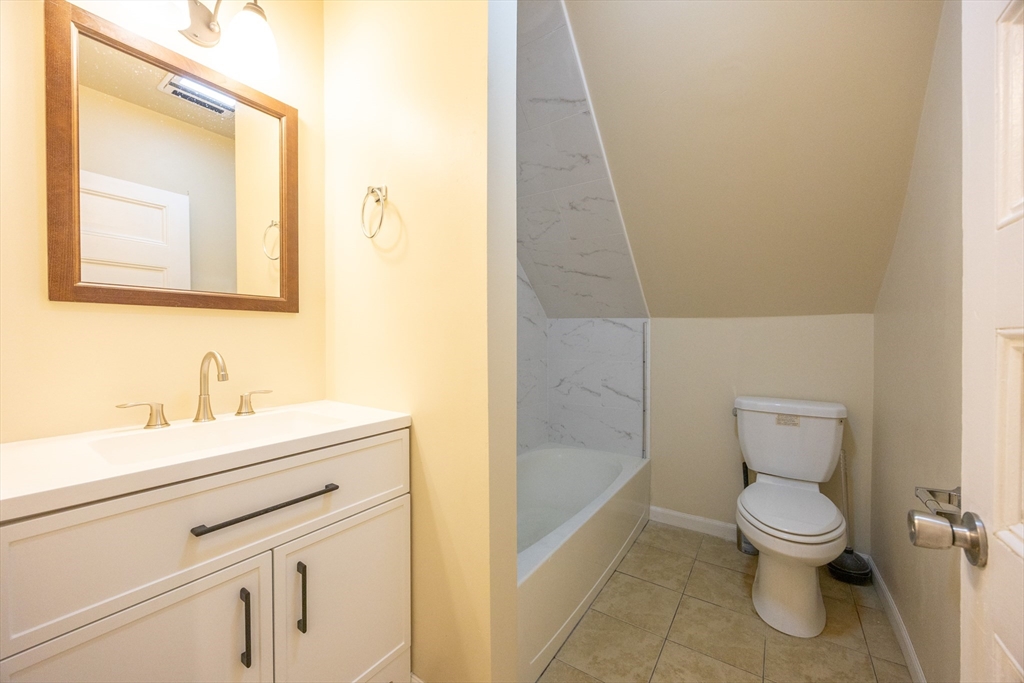 529 Adams Street, Unit 3 Boston, MA 02122 - Photo 7 of 11 a bathroom with a toilet a sink and mirror