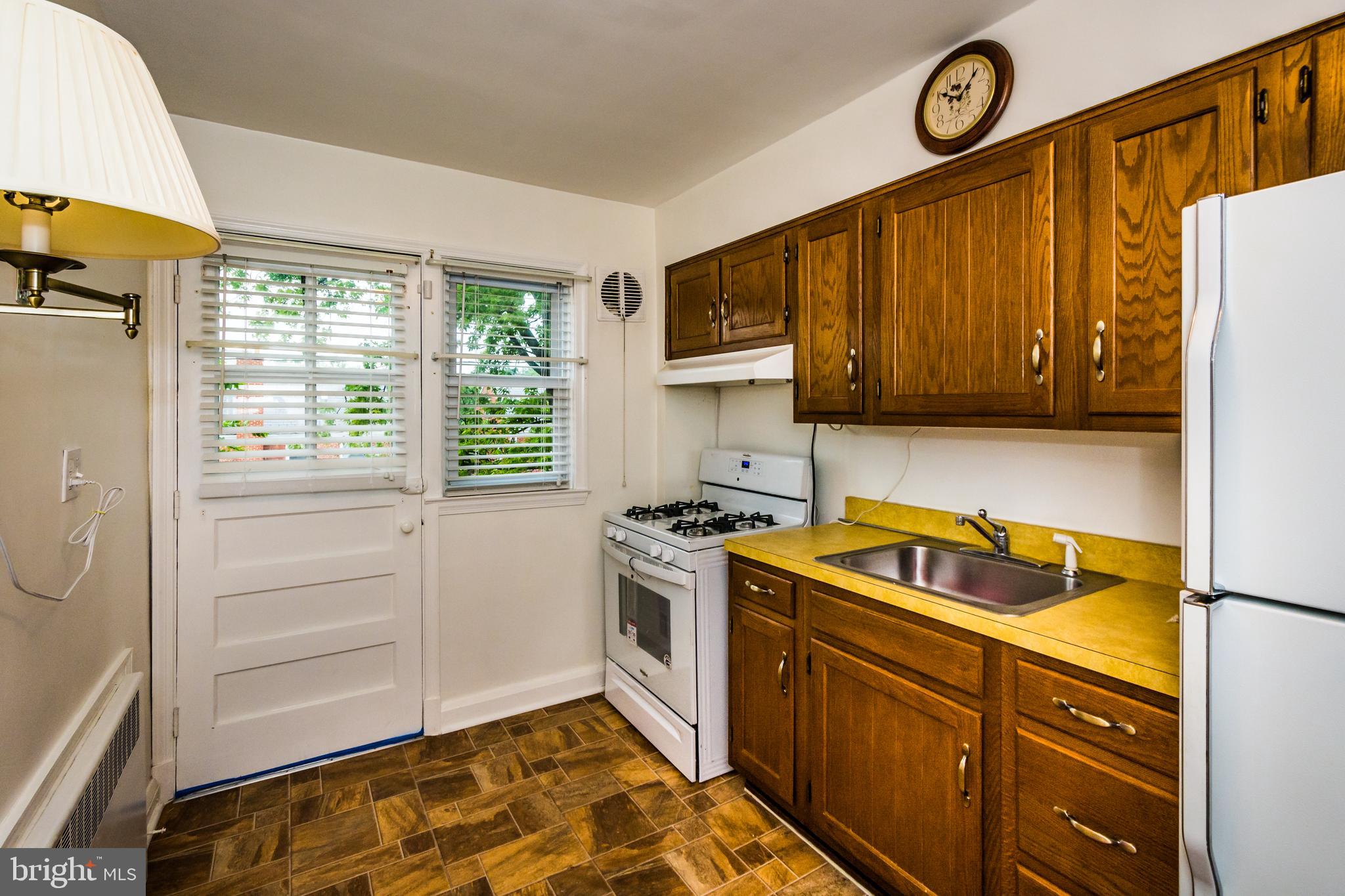 3829 Monterey Road Baltimore, MD 21218 - Photo 11 of 25 a kitchen with a stove and a microwave