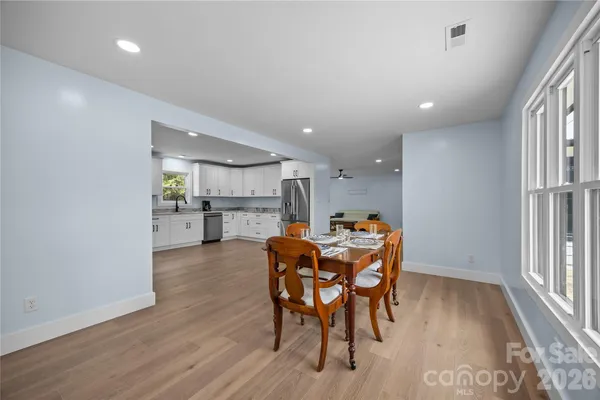 a dining room with furniture and wooden floor
