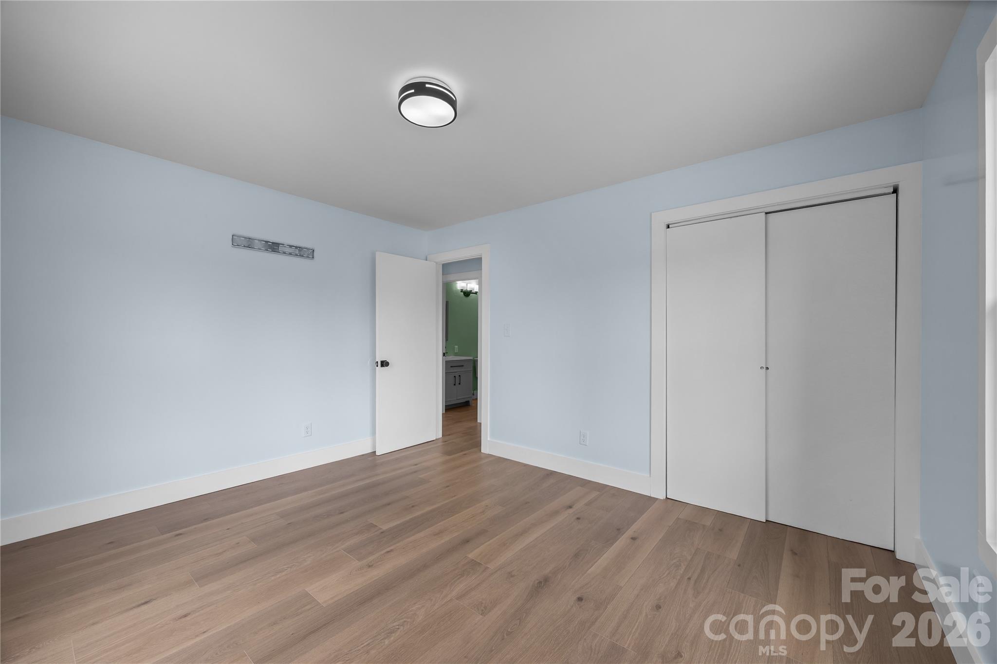 221 John C Logan Road Rutherfordton, NC 28139 - Photo 14 of 20 a view of an empty room with wooden floor and a window